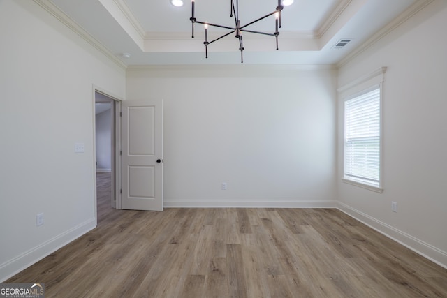 5704 Payton Pl, Lake Park, GA 31636 - spare room featuring a tray ceiling, a notable chandelier, and ornamental molding
