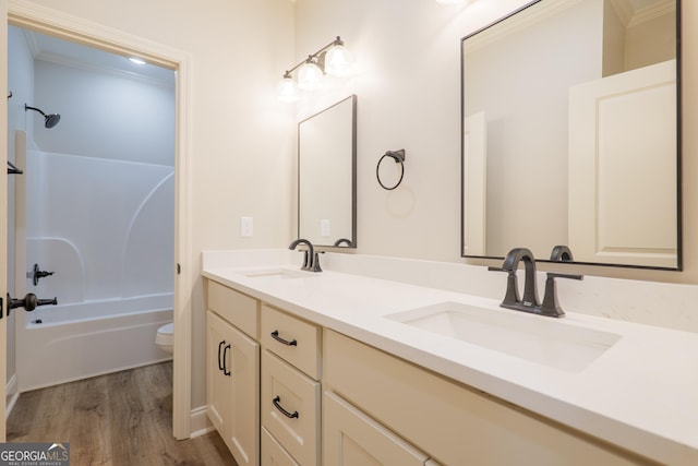 5704 Payton Pl, Lake Park, GA 31636 - bathroom featuring double vanity, wood finished floors, toilet, and a sink