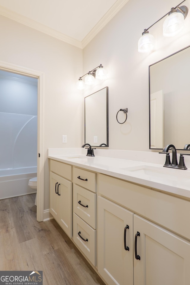 5704 Payton Pl, Lake Park, GA 31636 - full bath featuring double vanity, wood finished floors, ornamental molding, and a sink