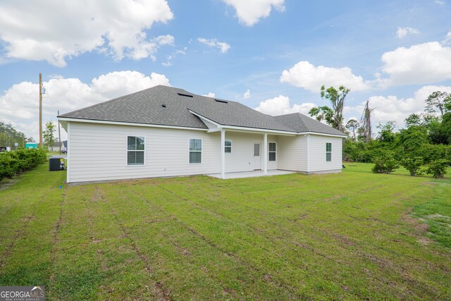 5704 Payton Pl, Lake Park, GA 31636 - back of property with a shingled roof, a lawn, central AC unit, and a patio