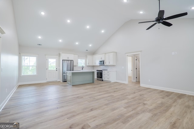 5704 Payton Pl, Lake Park, GA 31636 - unfurnished living room with high vaulted ceiling, visible vents, light wood finished floors, baseboards, and a ceiling fan