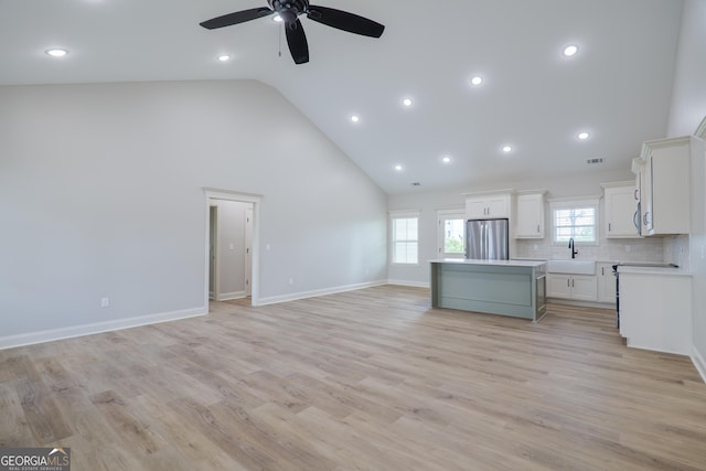 5704 Payton Pl, Lake Park, GA 31636 - unfurnished living room featuring a wealth of natural light, high vaulted ceiling, ceiling fan, and a sink
