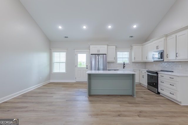 5704 Payton Pl, Lake Park, GA 31636 - kitchen featuring visible vents, a kitchen island, tasteful backsplash, appliances with stainless steel finishes, and white cabinetry