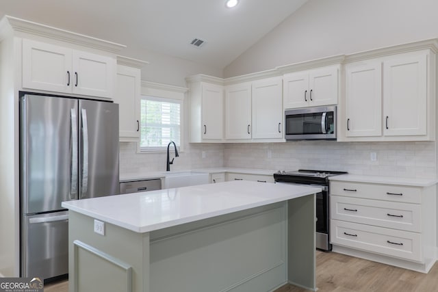 5704 Payton Pl, Lake Park, GA 31636 - kitchen featuring light countertops, vaulted ceiling, stainless steel appliances, a sink, and visible vents