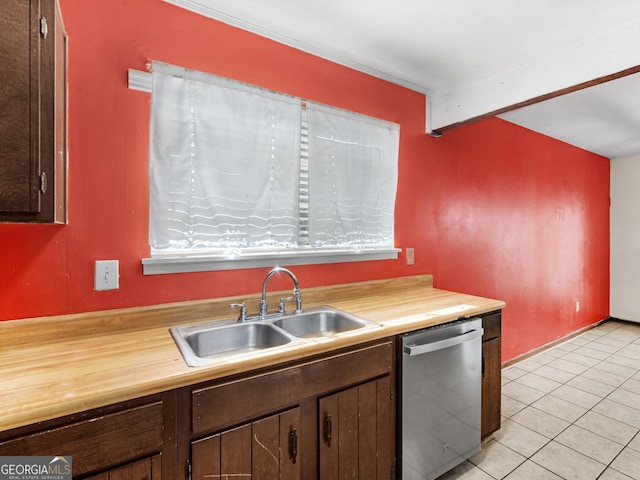 kitchen with stainless steel dishwasher, dark brown cabinetry, light tile patterned floors, and sink