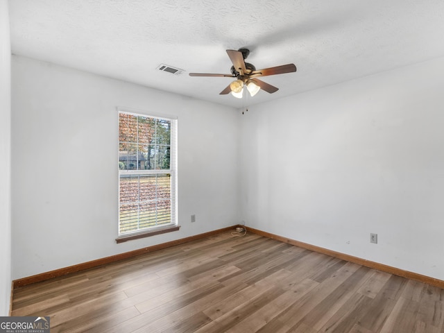 unfurnished room featuring hardwood / wood-style floors, a textured ceiling, and ceiling fan