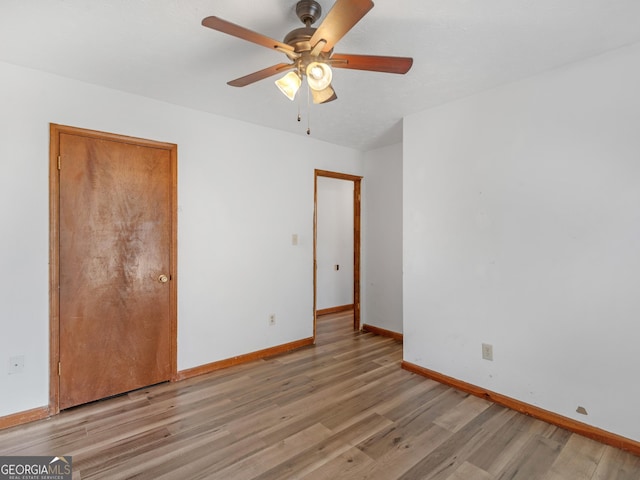 unfurnished bedroom with ceiling fan and light hardwood / wood-style flooring