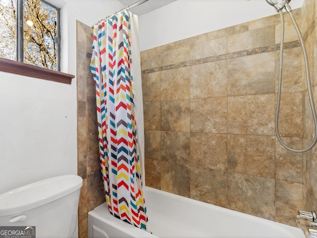 bathroom with toilet and shower / tub combo with curtain