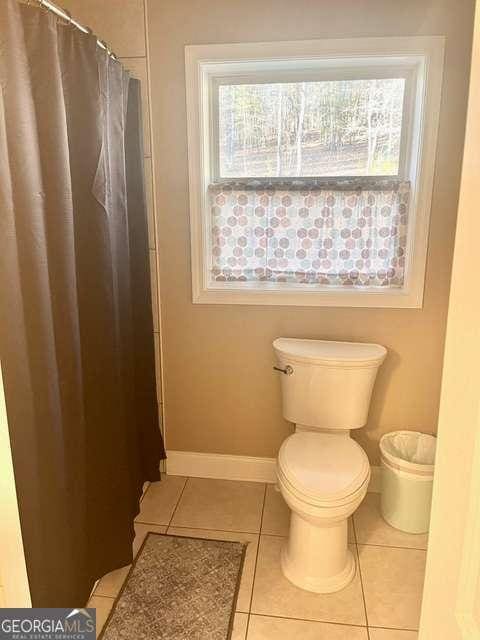 bathroom featuring tile patterned flooring and toilet