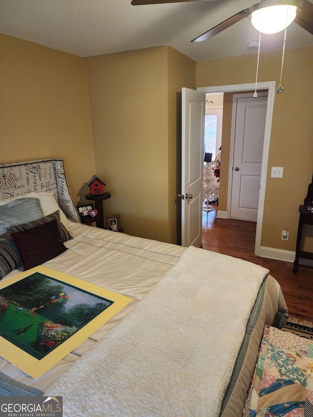 bedroom featuring ceiling fan and dark hardwood / wood-style floors