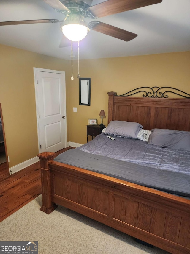 bedroom with ceiling fan and hardwood / wood-style floors