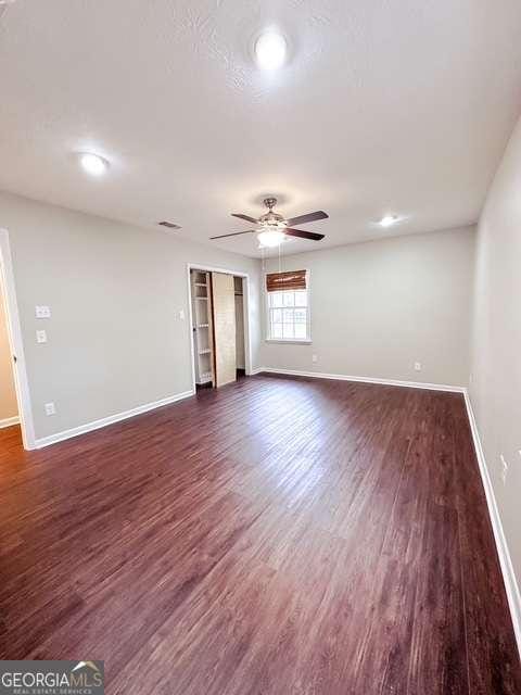 spare room with dark hardwood / wood-style floors