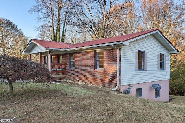 view of property exterior with a yard and covered porch