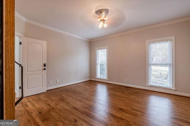 unfurnished room featuring plenty of natural light, ceiling fan, wood-type flooring, and crown molding