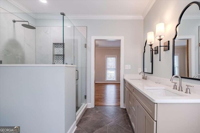 bathroom with hardwood / wood-style floors, vanity, a shower with door, and ornamental molding