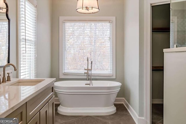 bathroom featuring tile patterned floors, plenty of natural light, and a bathtub