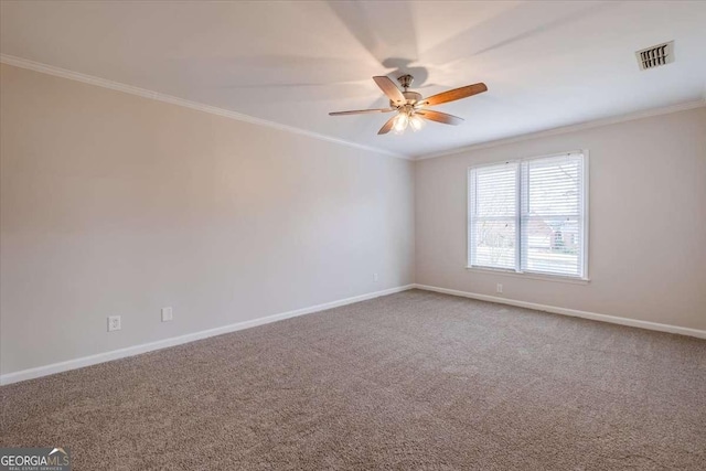 carpeted spare room featuring ceiling fan and crown molding