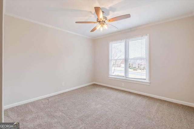 spare room with carpet flooring, ceiling fan, and crown molding