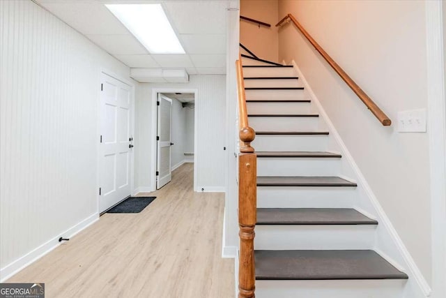 interior space with hardwood / wood-style flooring and a drop ceiling