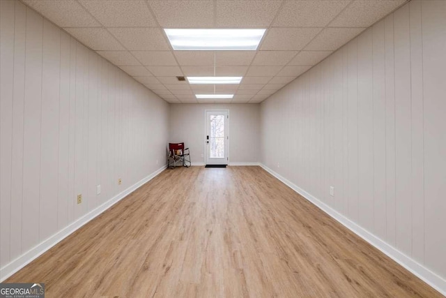 spare room with french doors, a paneled ceiling, and light hardwood / wood-style floors