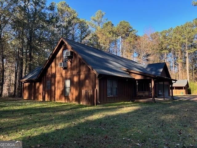 view of side of property with a yard