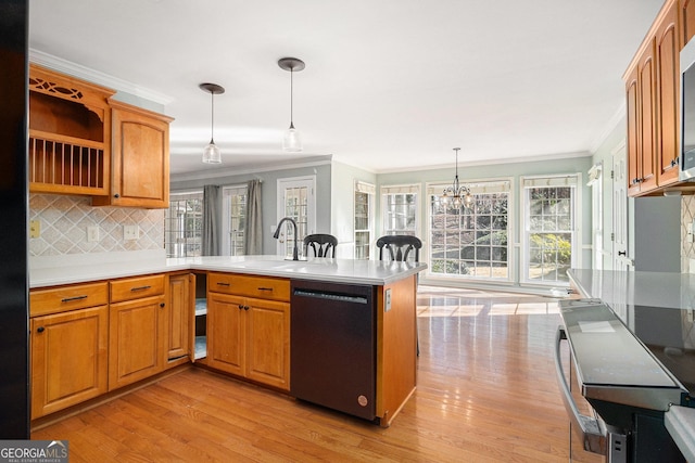 kitchen with crown molding, decorative light fixtures, black dishwasher, a notable chandelier, and kitchen peninsula