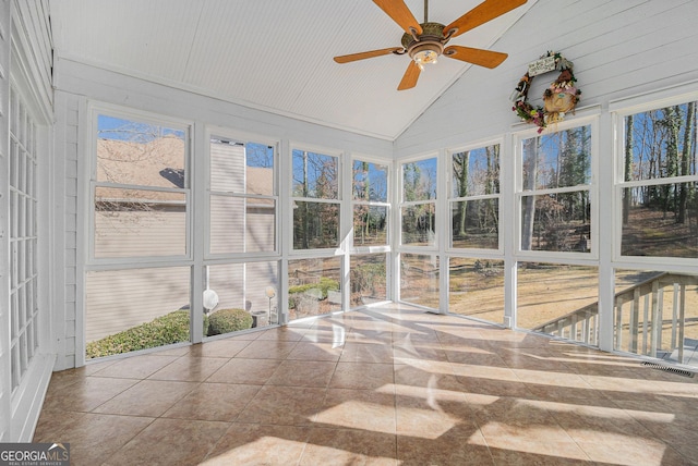 unfurnished sunroom featuring ceiling fan, lofted ceiling, and a wealth of natural light