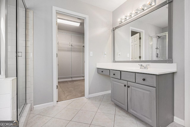 bathroom featuring vanity, tile patterned floors, and a shower with shower door