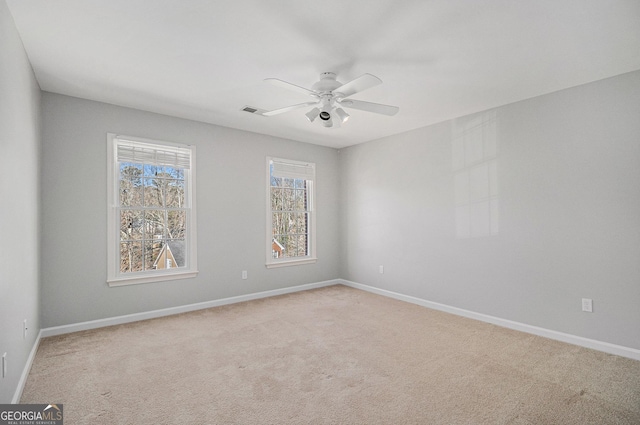 empty room with carpet floors and ceiling fan