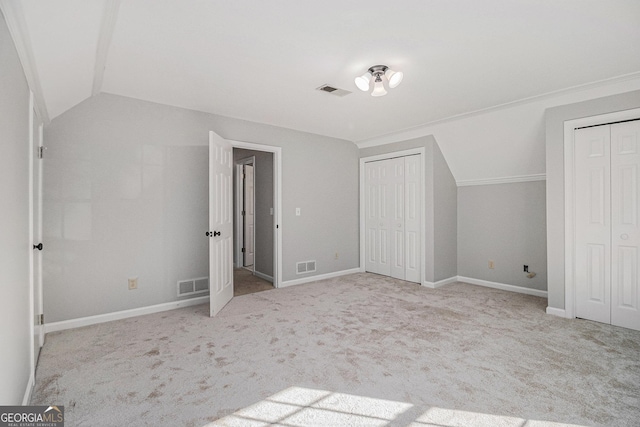 bonus room with light carpet and lofted ceiling