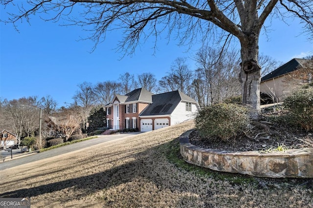 view of side of property with a lawn