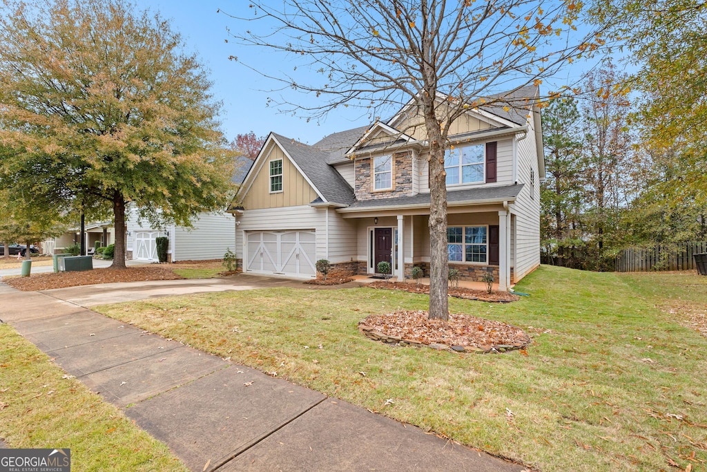 craftsman house featuring a front yard and a garage