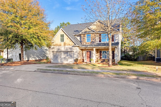 view of front of home with central AC and a garage