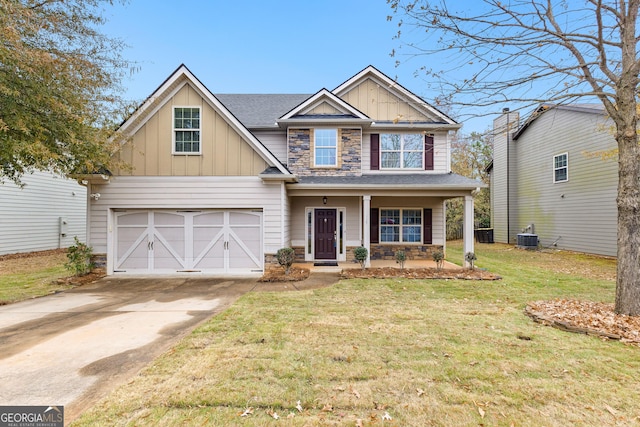 craftsman house with covered porch, a garage, a front lawn, and central air condition unit