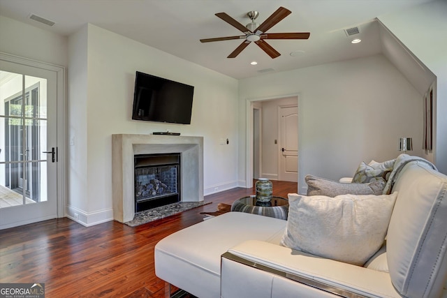 living room with ceiling fan and dark wood-type flooring