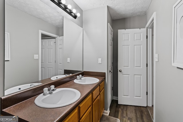 bathroom featuring vanity, a textured ceiling, and hardwood / wood-style flooring