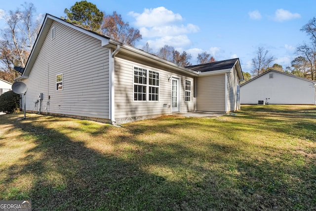 back of house featuring a yard and a patio