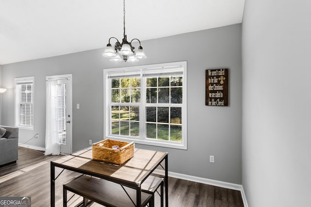 dining room with a chandelier and dark wood-type flooring