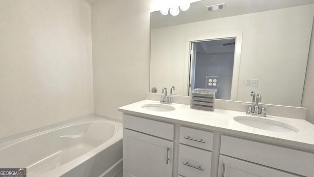 bathroom featuring a washtub and vanity