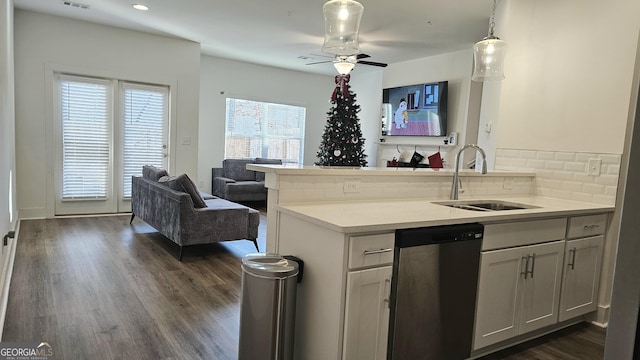 kitchen featuring dishwasher, backsplash, sink, decorative light fixtures, and dark hardwood / wood-style flooring