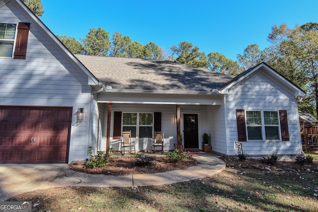 ranch-style home with covered porch and a garage