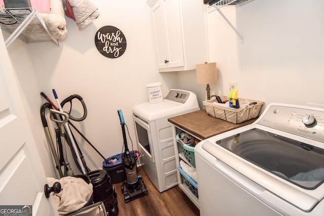 laundry room with dark wood finished floors, washing machine and dryer, and cabinet space