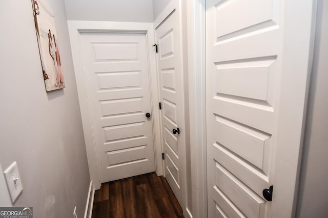 corridor featuring dark wood finished floors