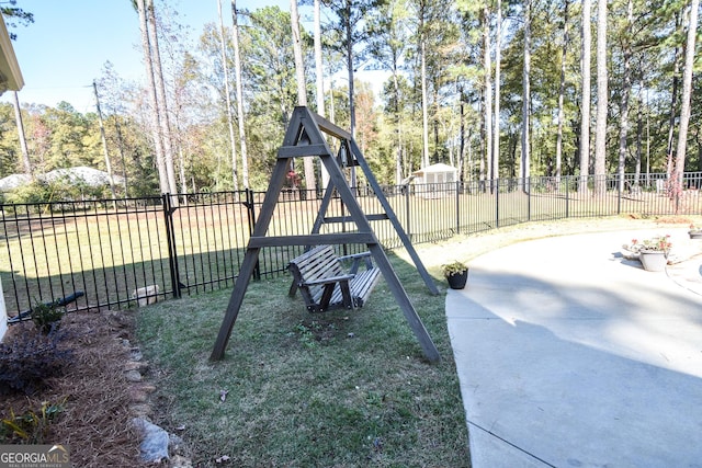 view of play area with a lawn and fence