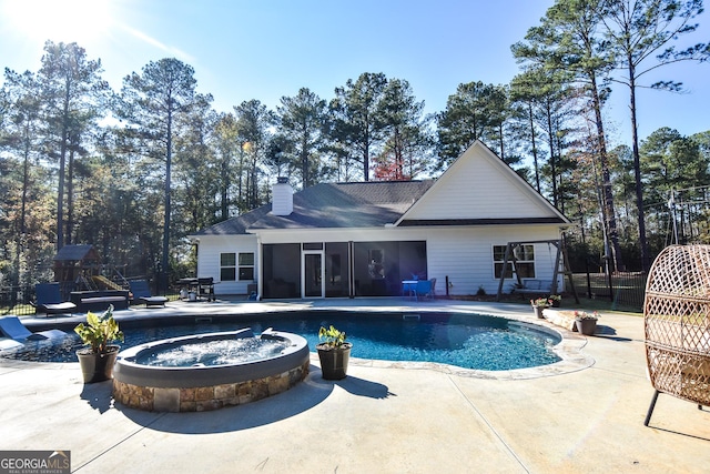 view of swimming pool with a patio area, a sunroom, and a fenced in pool