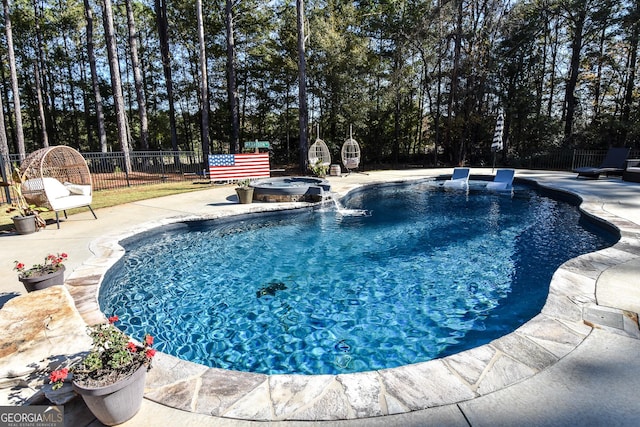 view of swimming pool featuring an in ground hot tub, a patio area, fence, and a fenced in pool