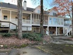 rear view of property featuring a wooden deck