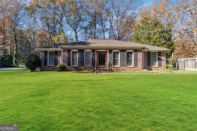 single story home featuring a front lawn