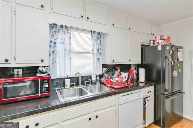 kitchen featuring white cabinets, light wood-type flooring, sink, and appliances with stainless steel finishes