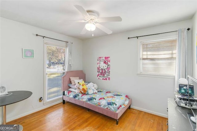 bedroom with ceiling fan and wood-type flooring